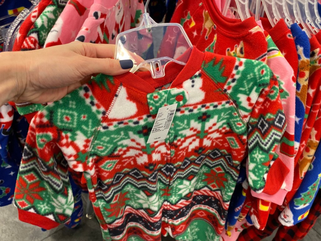 Hand holding children's Christmas pajamas