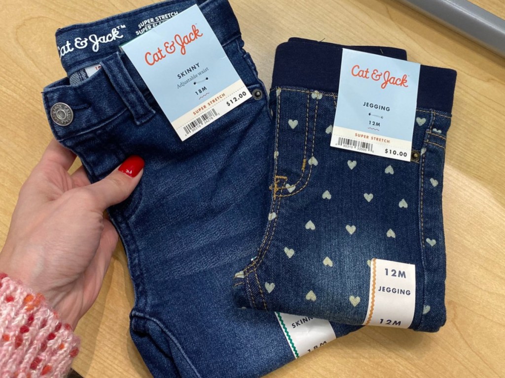 Hand holding Cat & Jack toddler jeans at Target 