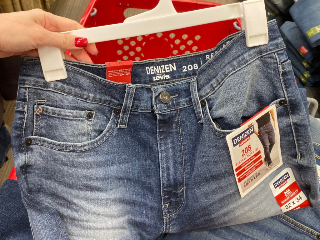 hand holding men's jeans at target 