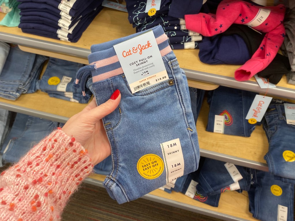 woman's hand holding target jeans at target 