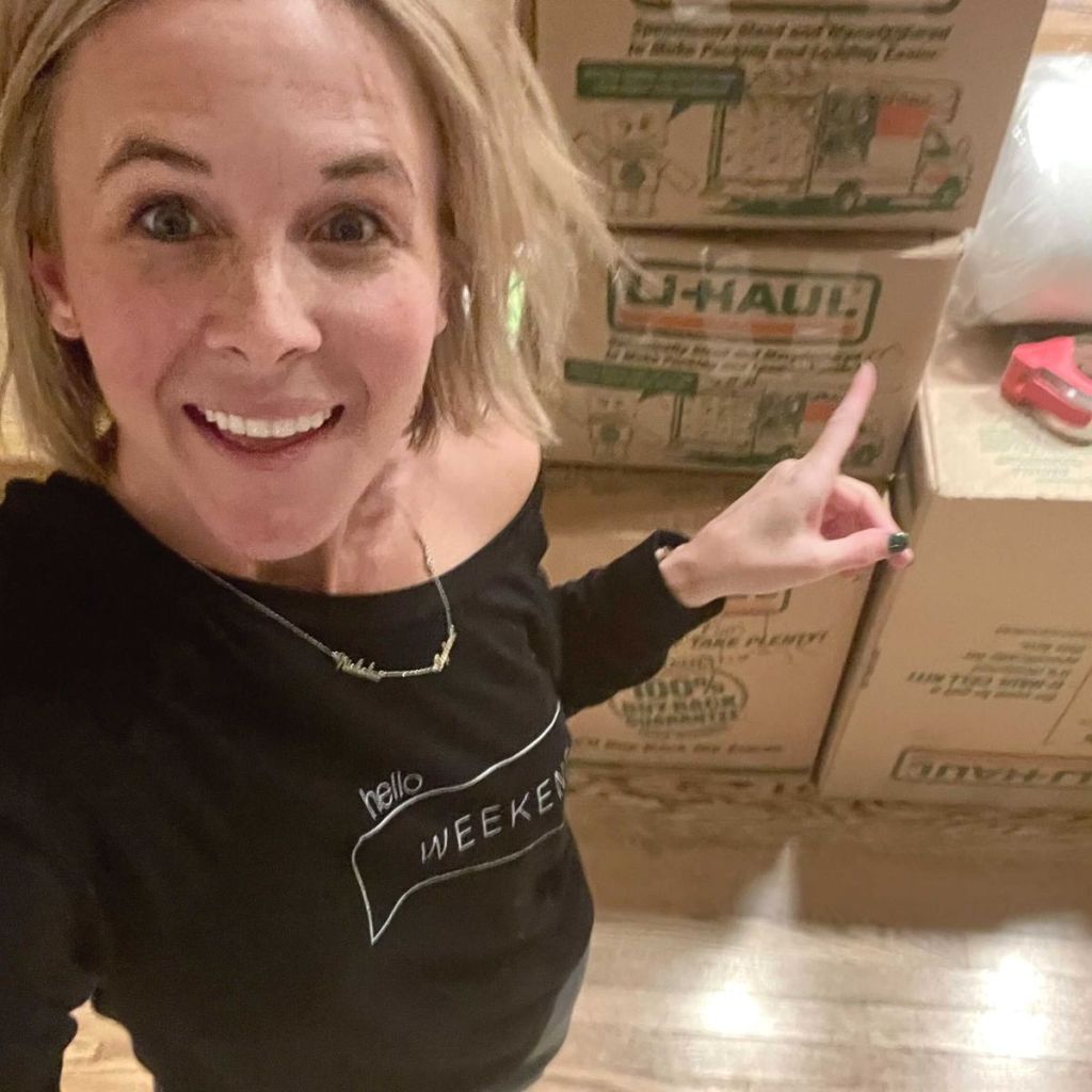 A woman pointing to moving boxes