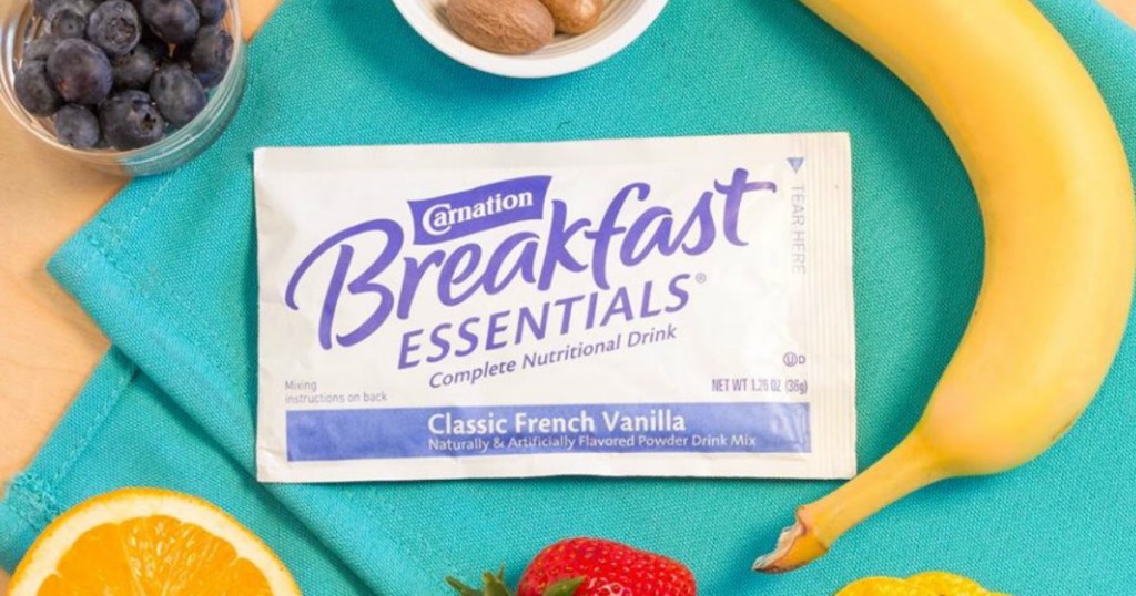 Carnation Breakfast Essentials Classic French Vanilla packet surrounded by fruit
