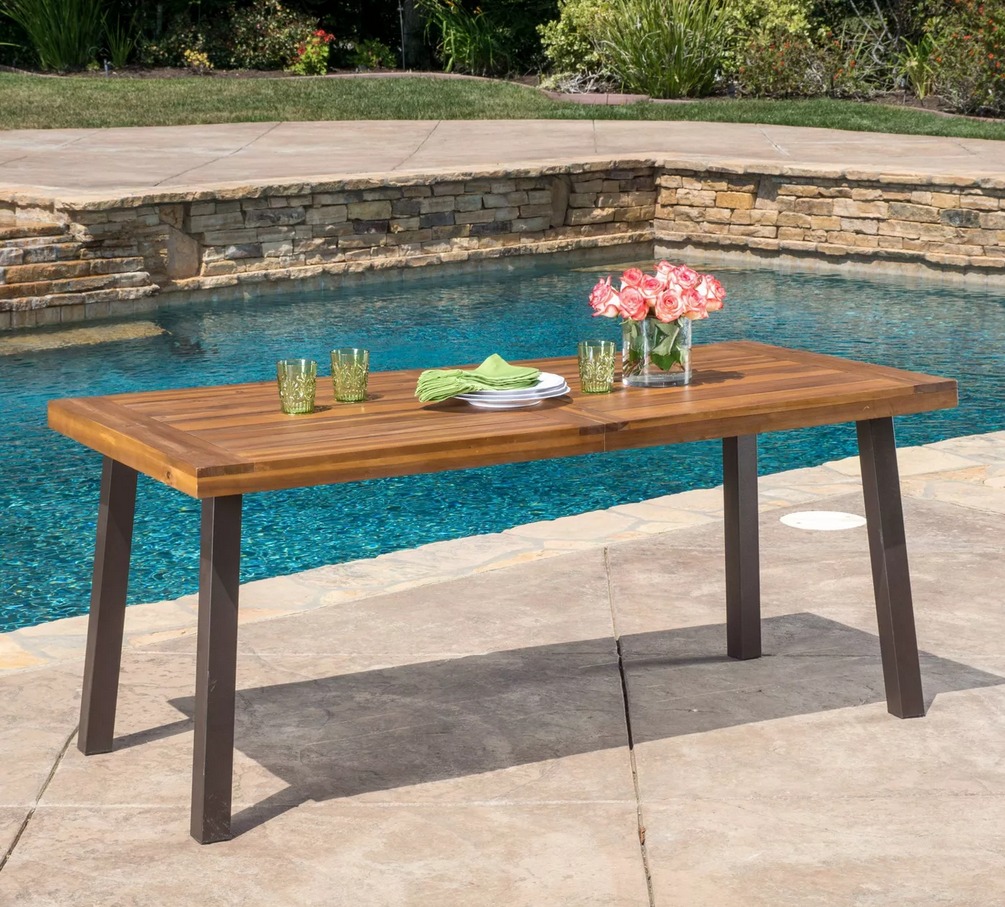 Christopher Knight Teak Table in front of pool