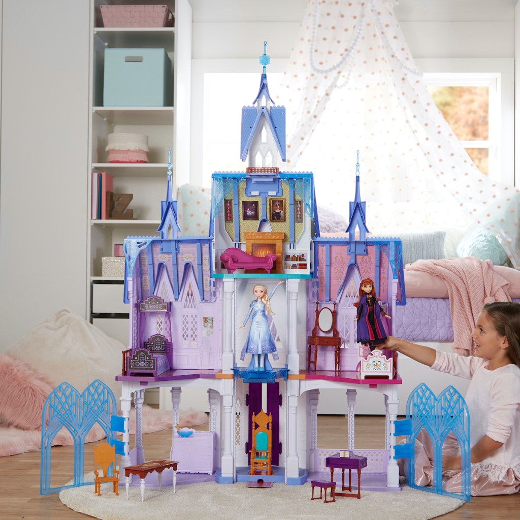 girl playing with Disney Frozen Ultimate Arendelle Castle in bedroom