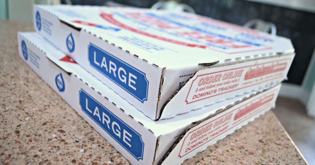 two large dominos pizza boxes on counter