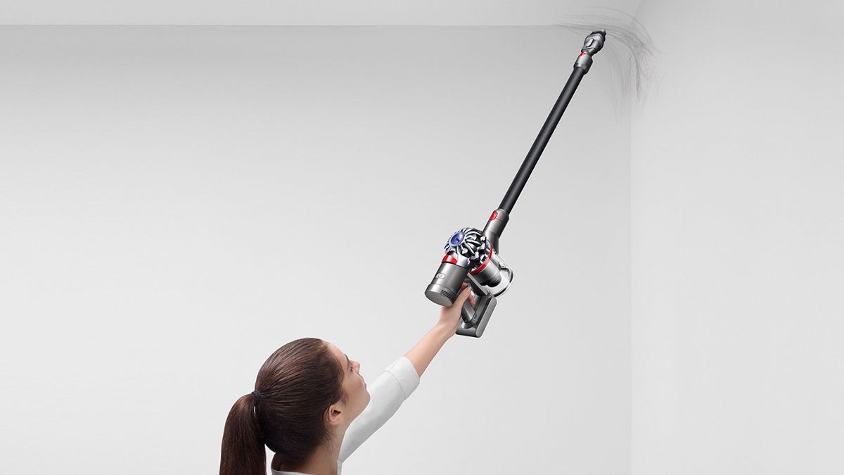 woman using a Dyson Vacuum