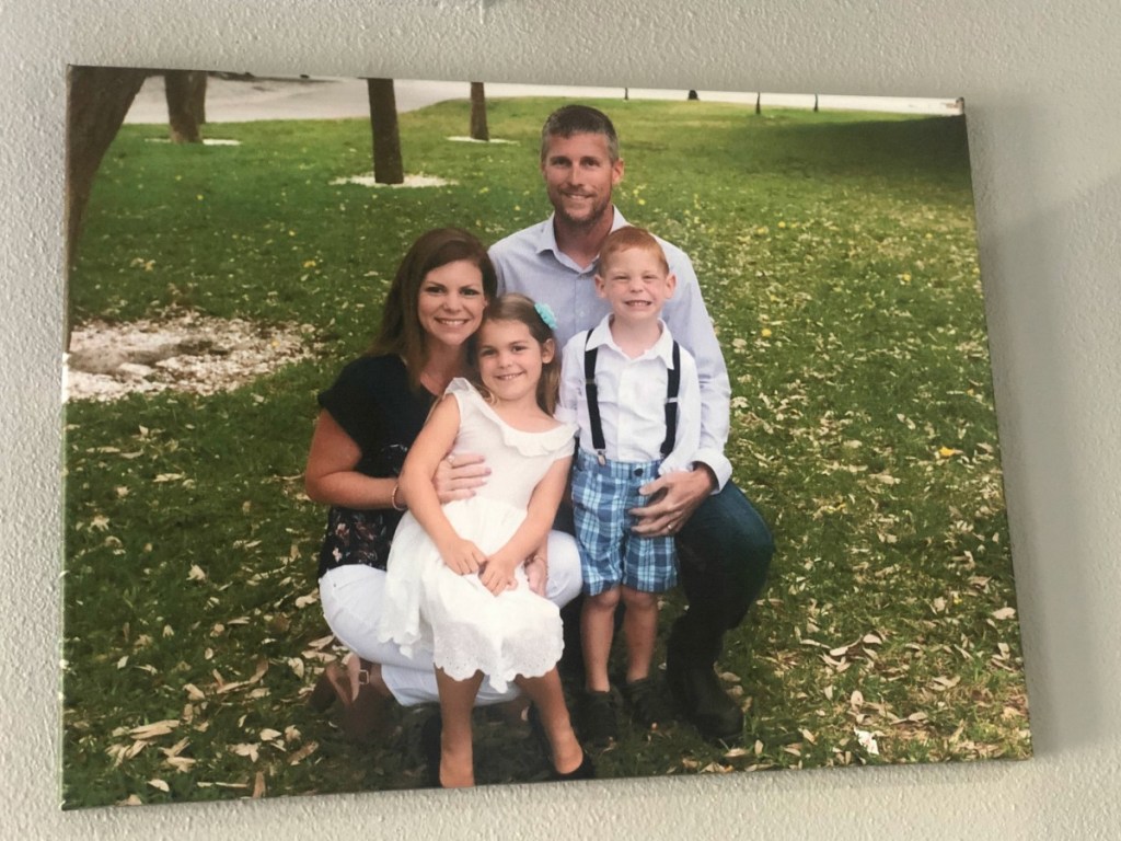 Family posing together in a park printed on a canvas, hanging on a wall