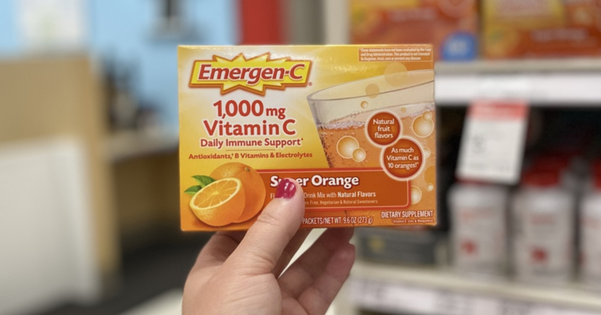 woman hand holding Emergen-C Immune+ Orange box of 30