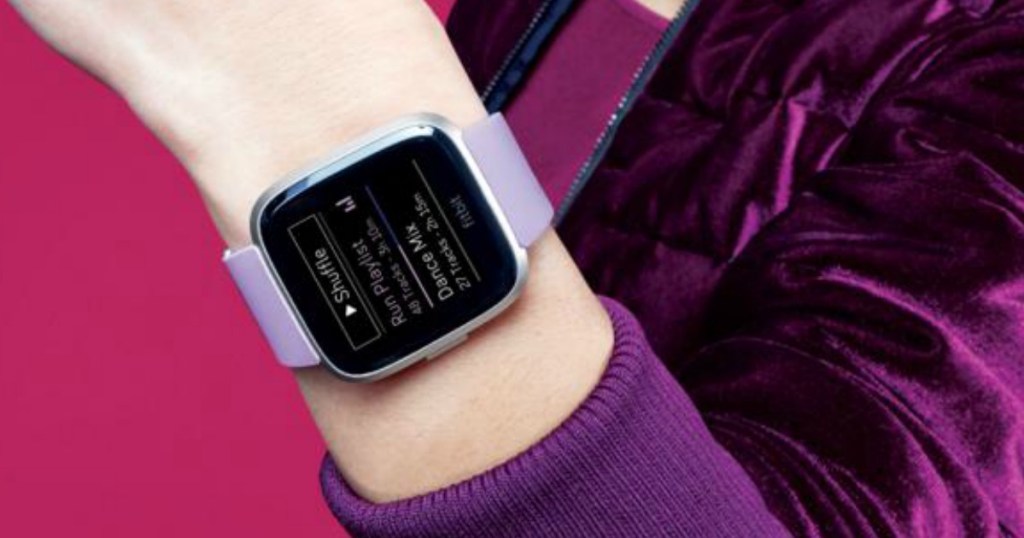Woman wearing a FitBit Versa smartwatch