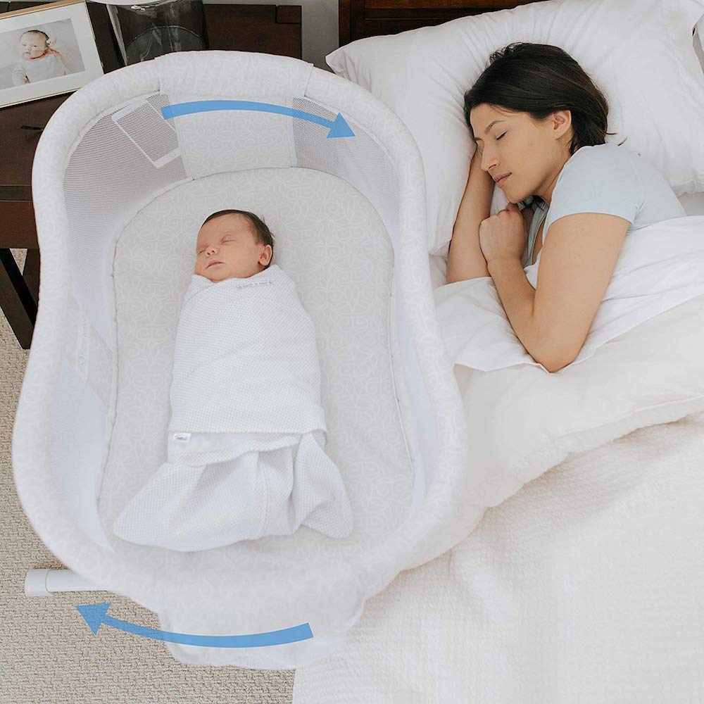 baby laying in a Halo Bassinest Sleeper by mom