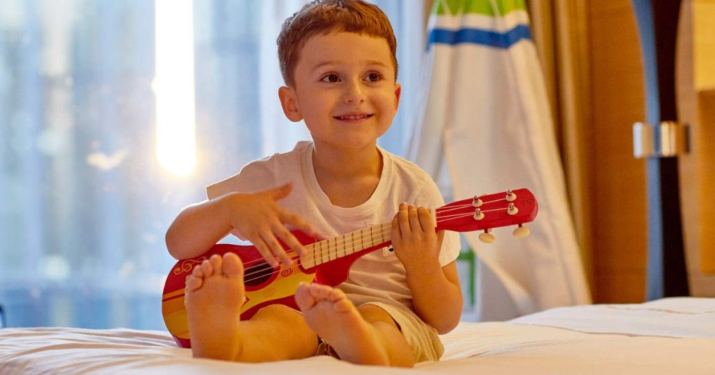 boy playing ukulele 