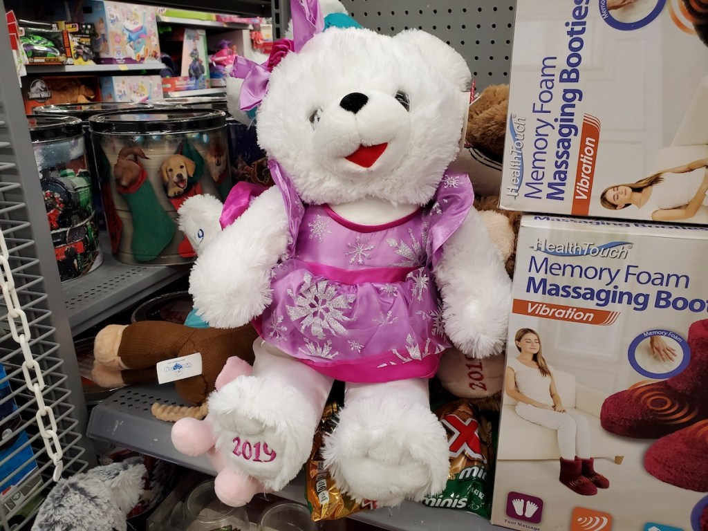 Holiday Time Bear sitting with other toys on shelf