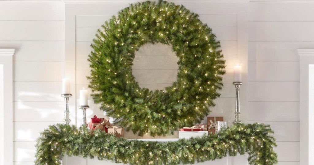 circle wreath hanging on wall with garland underneath
