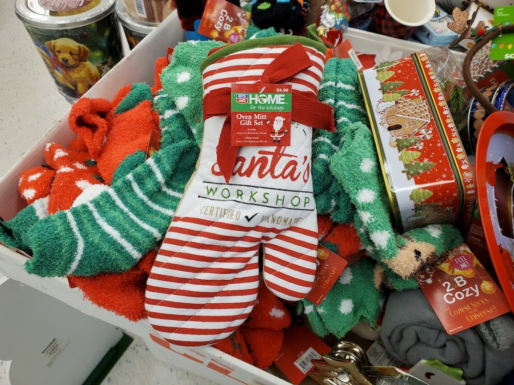 Home for the Holidays Oven Mitt Gift Set sitting on pile of holiday socks