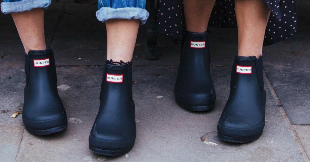 Women wearing Hunter Boots on sidewalk