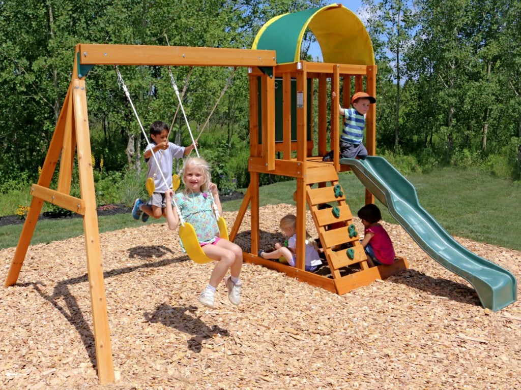 Kids playing on a KidKraft wooden playset