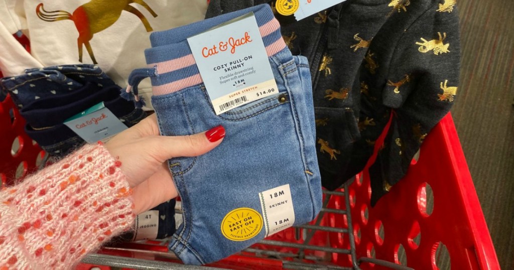 Cat & Jack Kids Clothes in hand near Target shopping cart