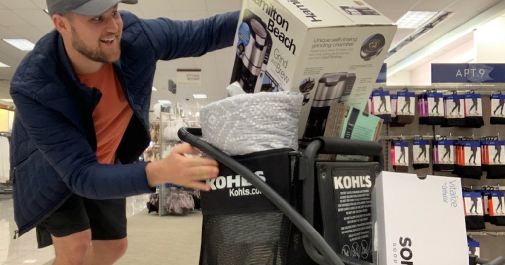 Man filling Kohl's shopping cart, in-store