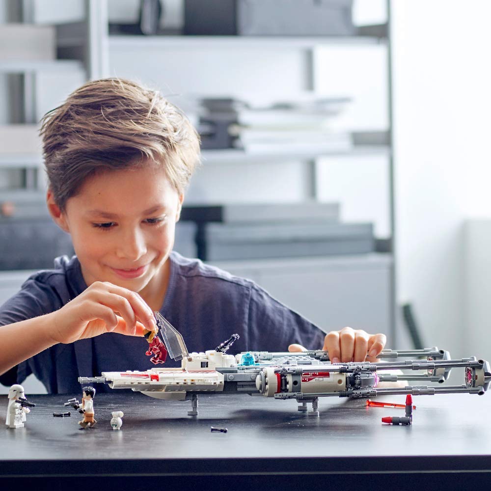 boy playing with LEGO Y-wing