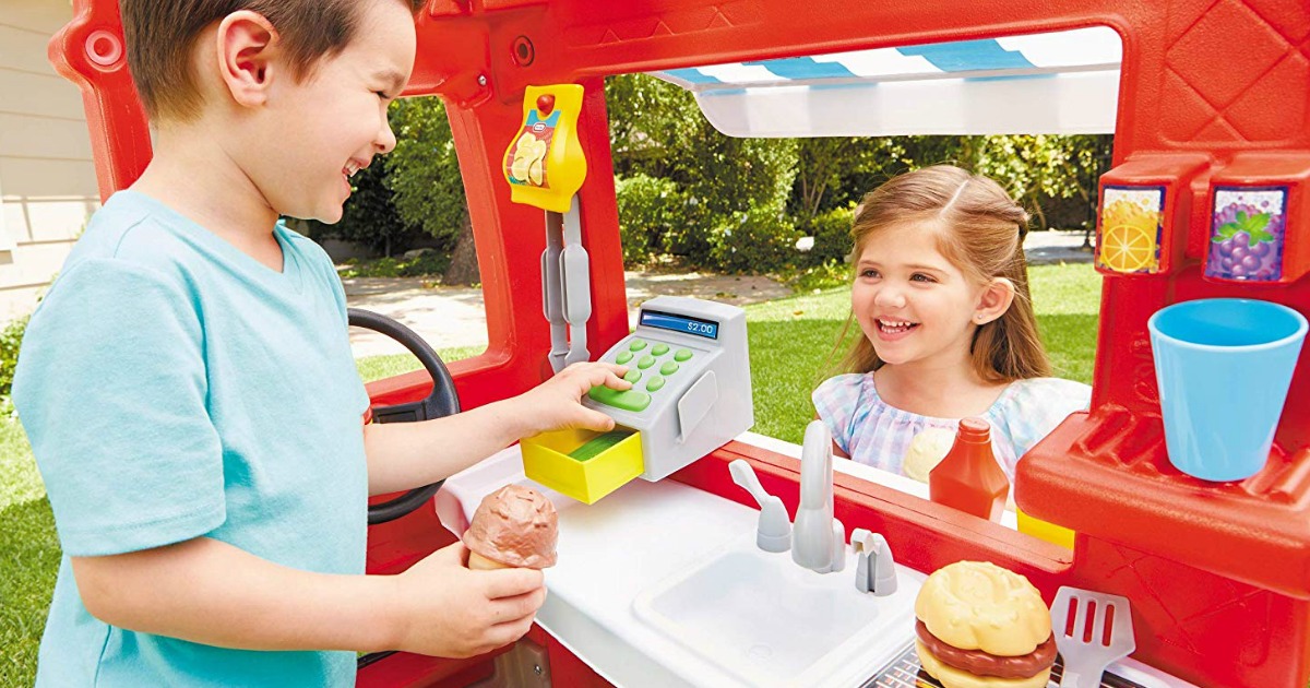 Kids playing with a Little Tikes 2-in-1 food truck outside