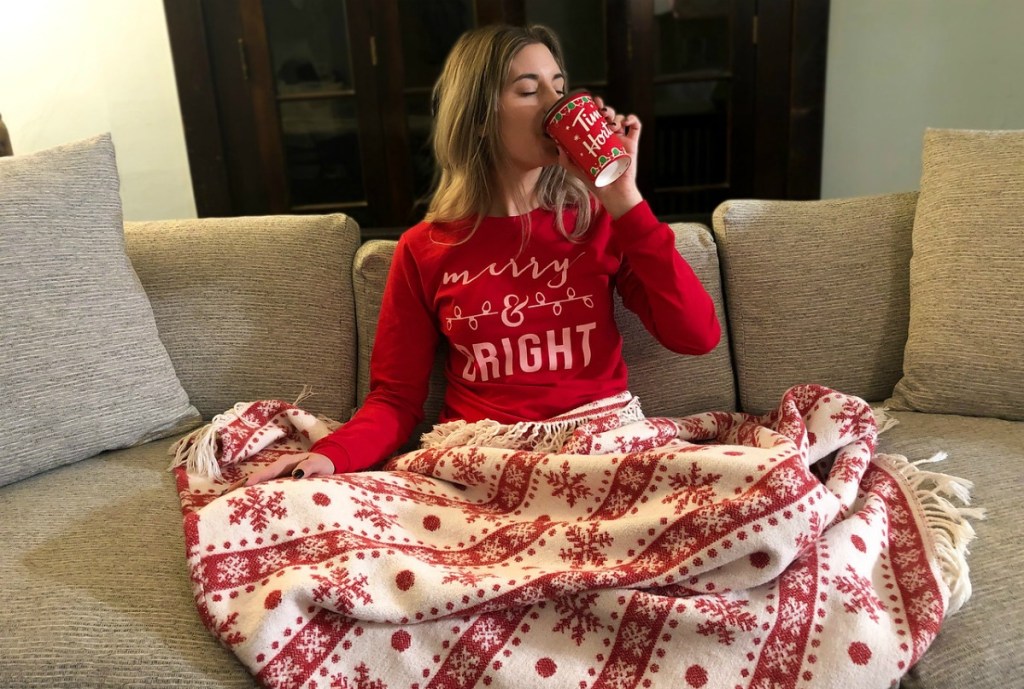 woman drinking coffee and wearing Merry & Bright long sleeve shirt