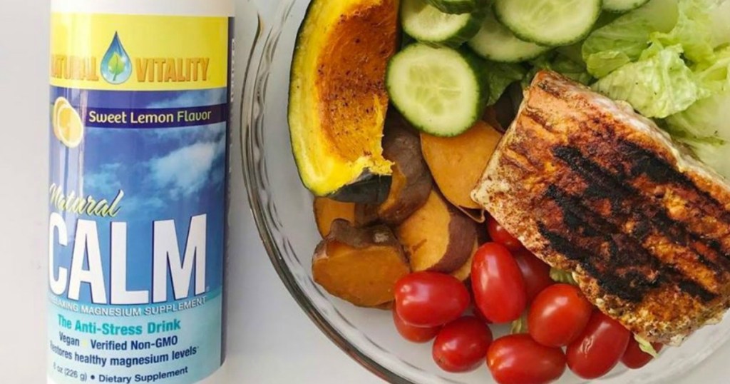 Natural Vitality Natural Calm lemon drink mix next to a plate of food