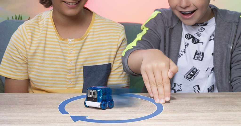 two kids playing with novie smart robot toy