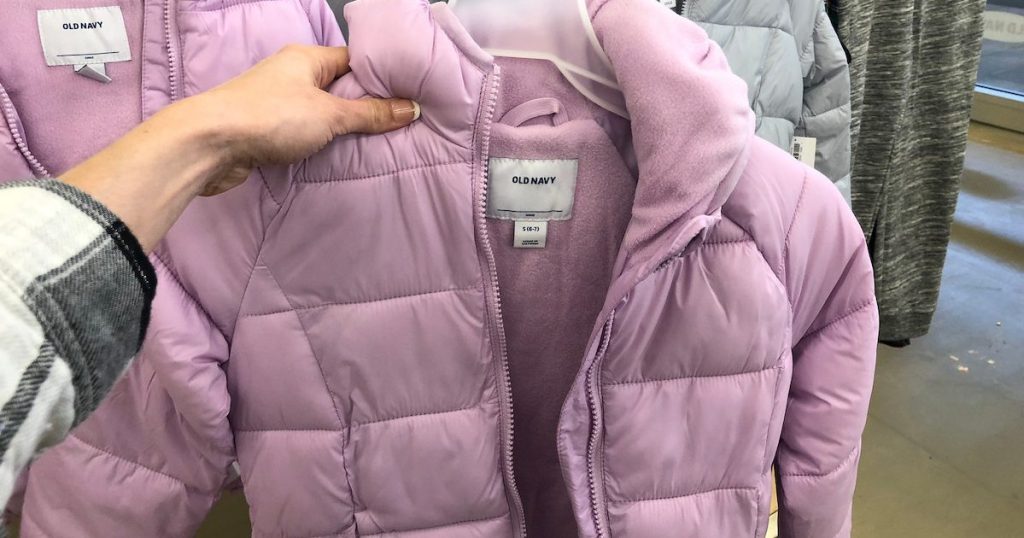 woman hold up Pink girls old navy frost free jacket in store