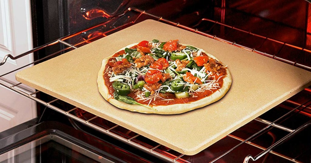 rectangular pizza stone with pizza in oven