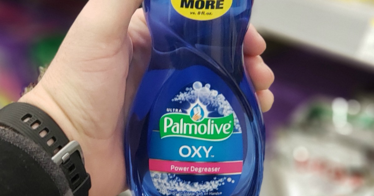 hand holding a bottle of Palmolive Oxy