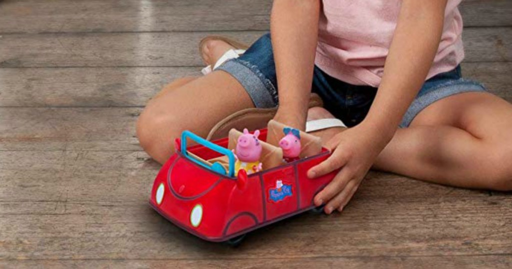 Girl playign with Peppa Pig red Car