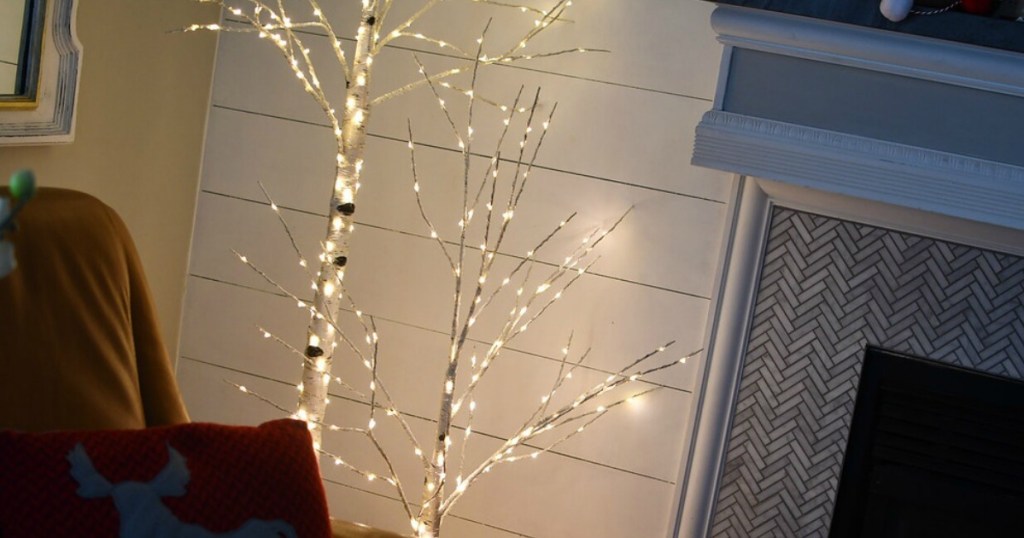 Philips 4' Pre-lit Artificial Birch Twig Christmas Trees by a fireplace