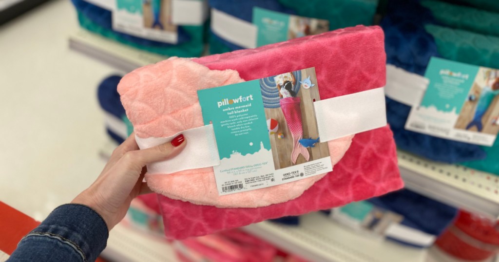 woman hand holding Pillowfort Pink Mermaid Tail Blanket