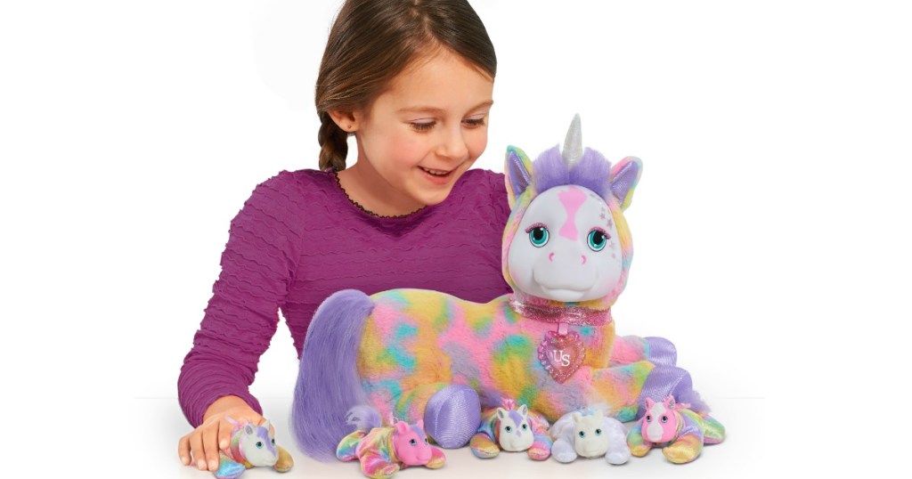 girl playing with multicolored plush unicorn