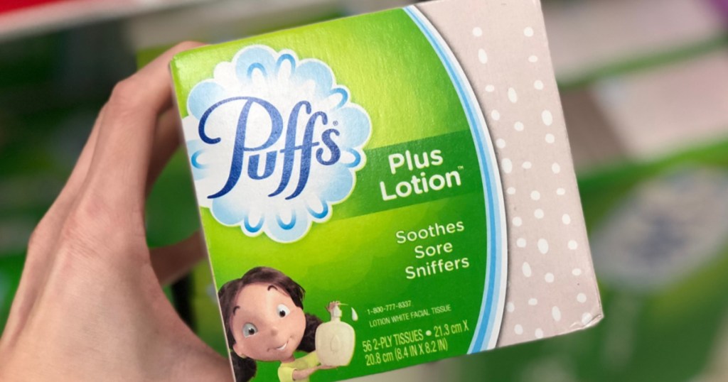 Hand holding Puffs Plus with Lotion 