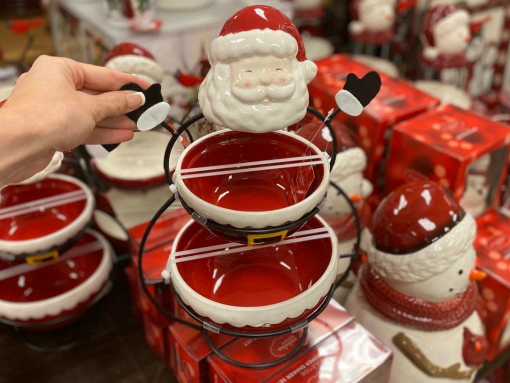 Hand holding a Santa Claus-themed two-tier serving tray