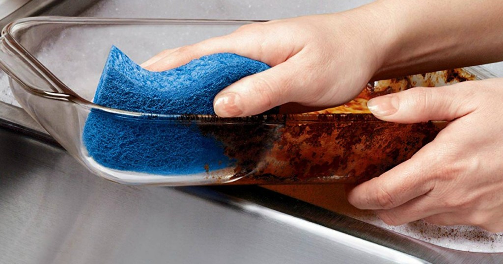 hand cleaning a pan using a Scotch-Brite Non-Scratch Sponge