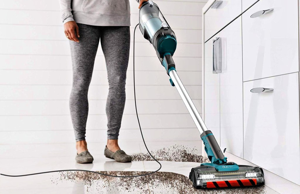 Shark APEX UpLight Lift-Away DuoClean with Self-Cleaning Brushroll Stick Vacuum used by woman in kitchen