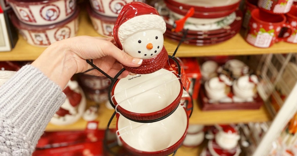 Hand holding a snowman-themed two-tier serving tray