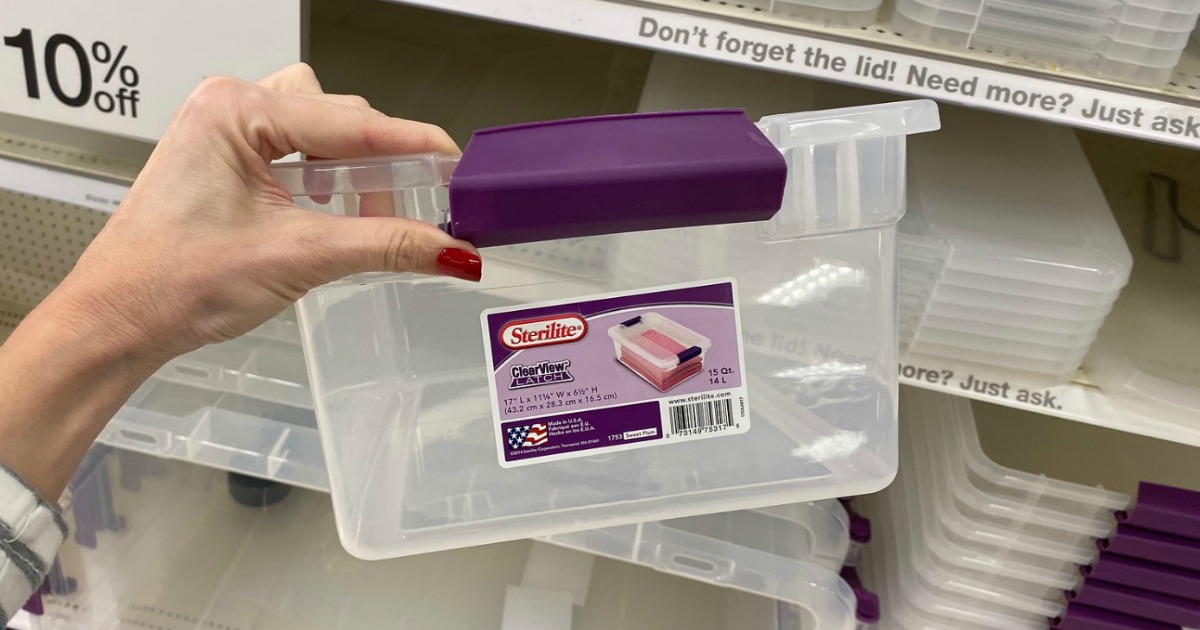 Plastic storage container with purple clips in hand at Target