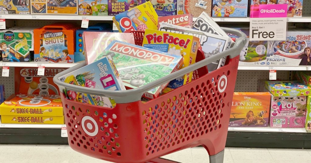 A bunch of board games in a big red Target shopping cart