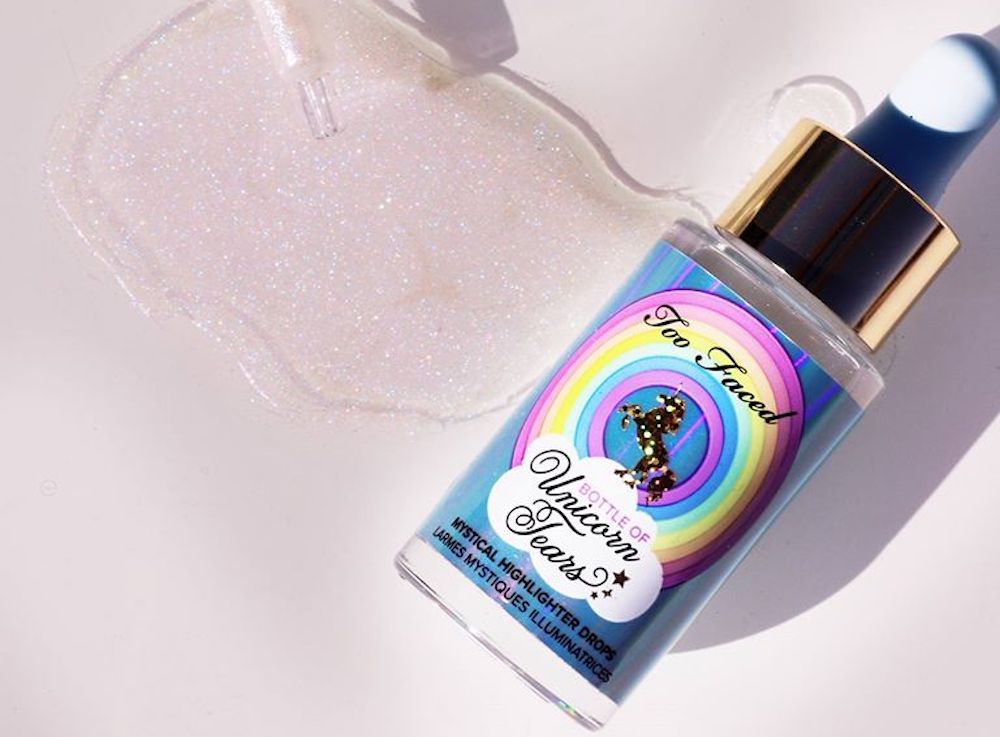 Too Faced Unicorn Tears bottle with spill next to it