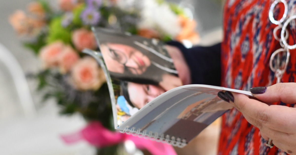 woman looking through a photo book graduation gifts
