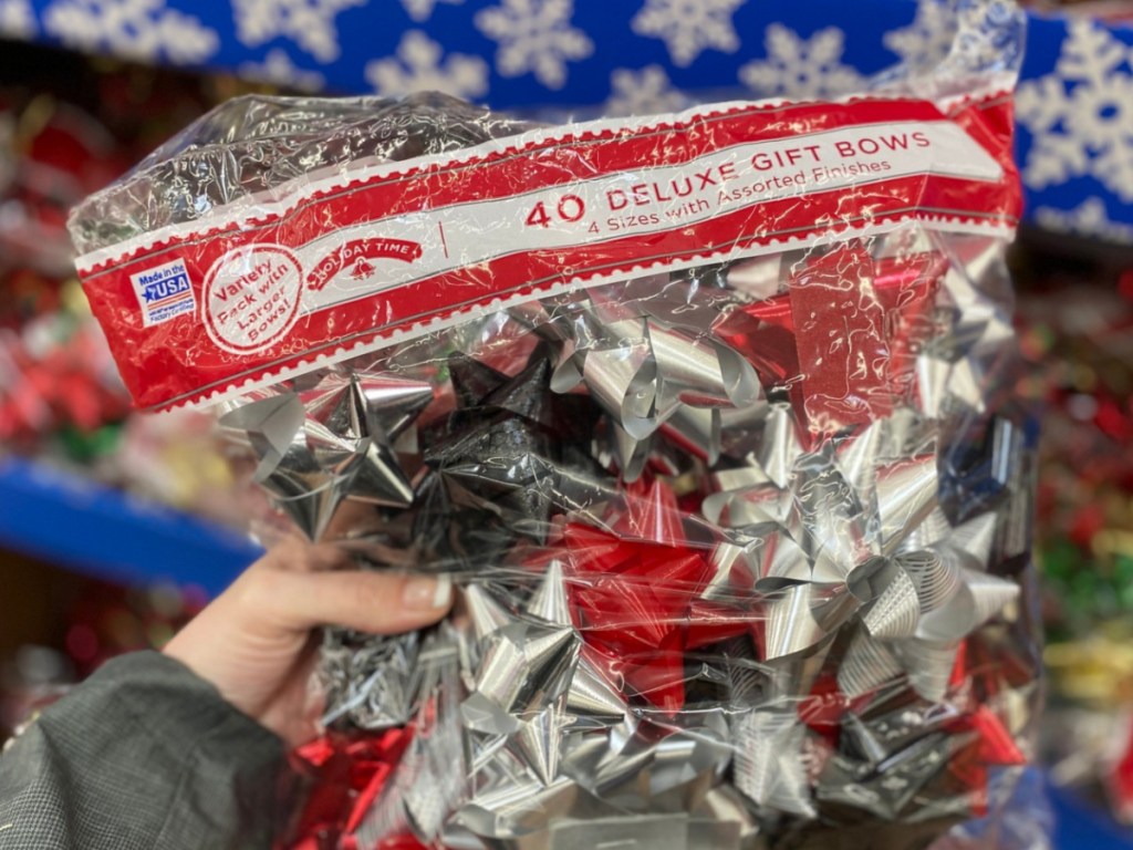 Hand holding deluxe Holiday Time Gift Bows at Walmart 