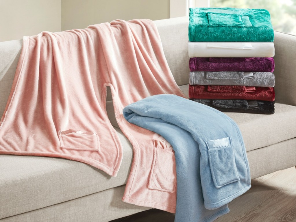 Wearable blankets from walmart laying on a couch