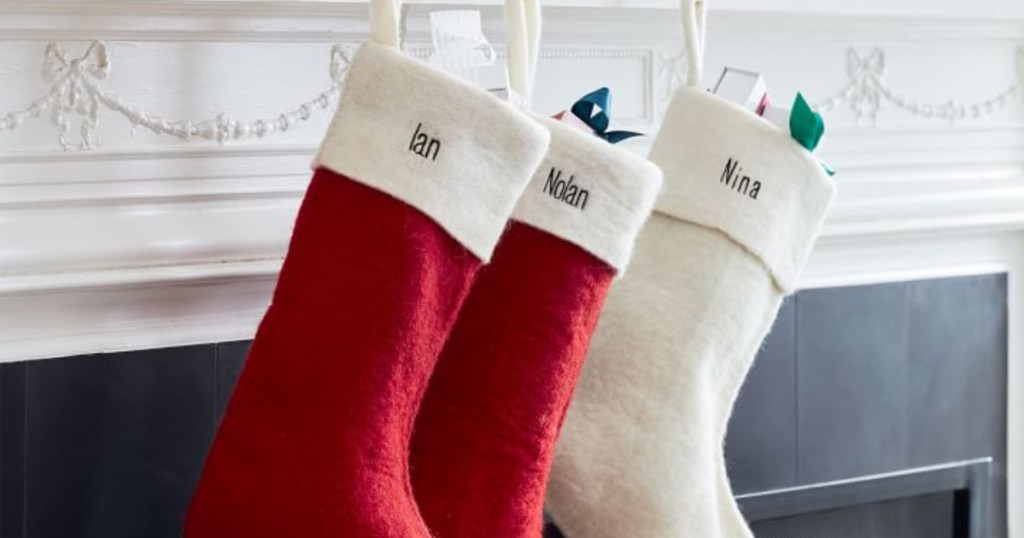 West Elm Felt Christmas Stocking on mantle with items in stocking