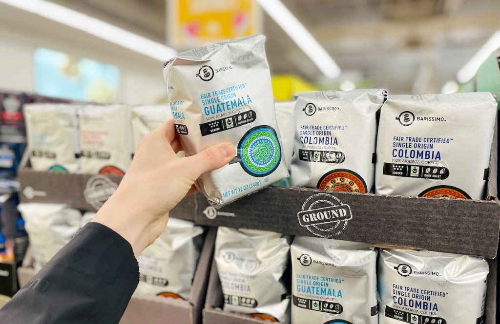 hand holding package of fair trade ground coffee at aldi