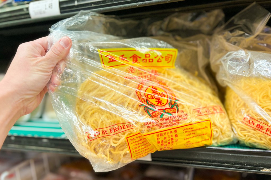 hand grabbing bag of noodles