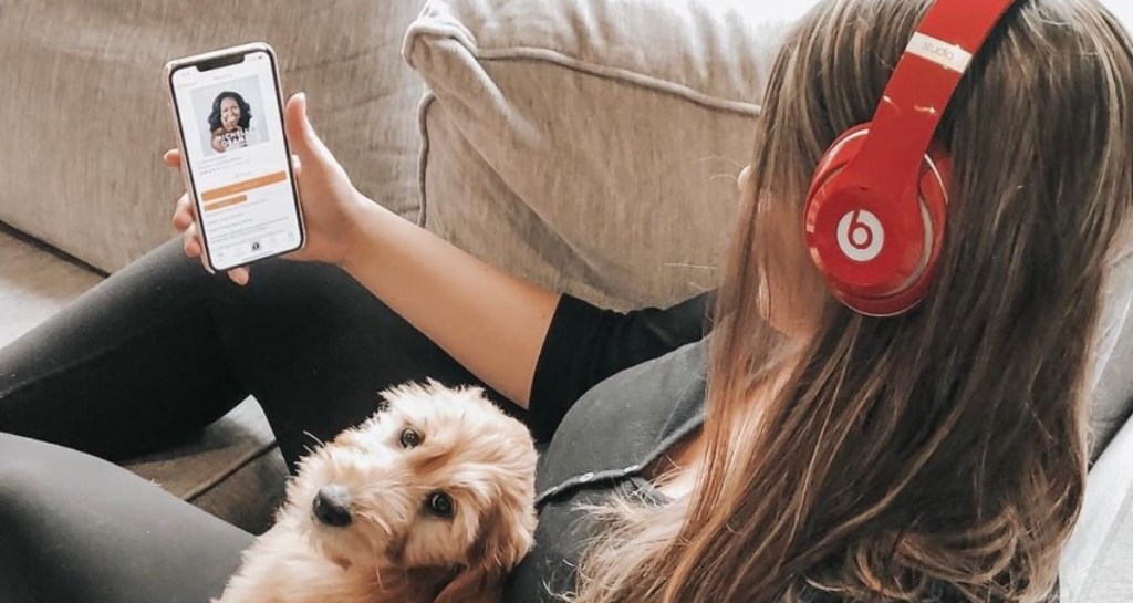 girl with dog listenint to Audible on Beats