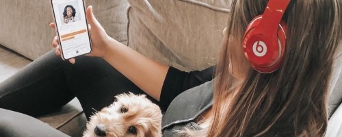 girl with dog listenint to Audible on Beats